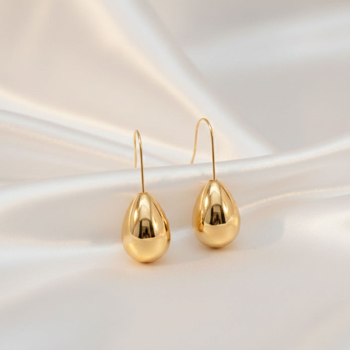 Boucles d’oreilles argentées en forme de goutte brillante.