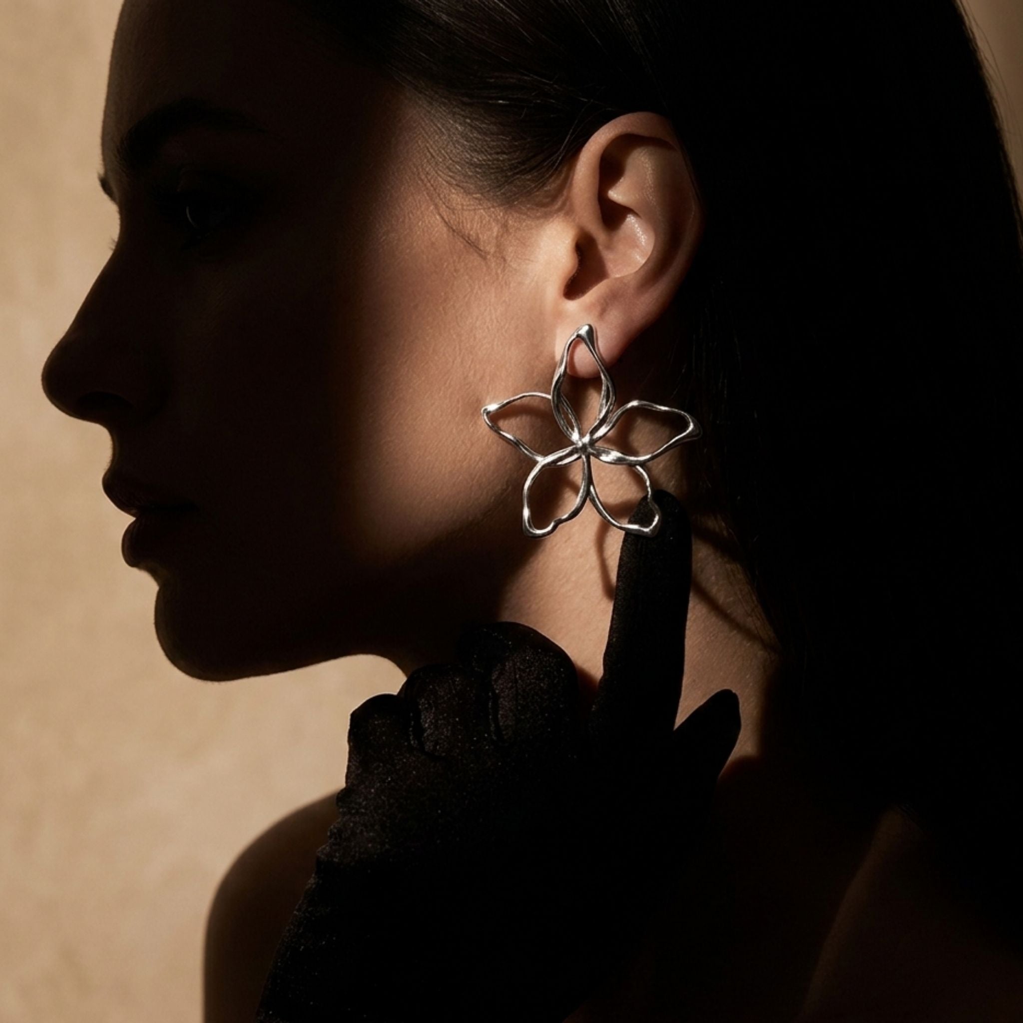 Boucles d’oreilles fleurs argentées ajourées effet miroir.